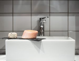 Bathroom with two bars of fine soap near the washbasin. Hygiene and care fixture installation near Mango, FL