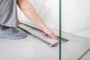Finishing Linear Shower Drain. Modern Raw Concrete Floor. Bathroom Remodeling Theme. brandon fl