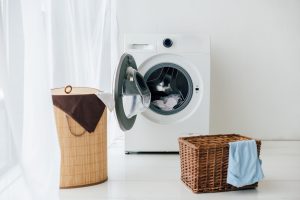 opened washer and brown baskets in laundry room in Gibsonton, FL