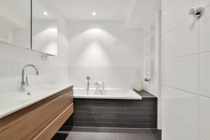 Bathroom interior in a modern style and with white classic tiles and wall in Apollo Beach
