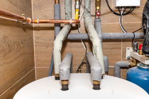 Water tank and gas pipes for a modern gas boiler in a home boiler room, lined with ceramic tiles in lithia fl